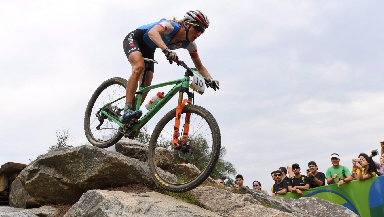 Mountain biker going over rock 