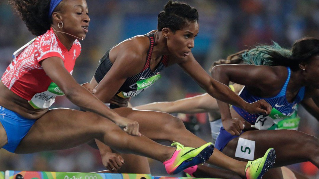 Runners competing in hurdles