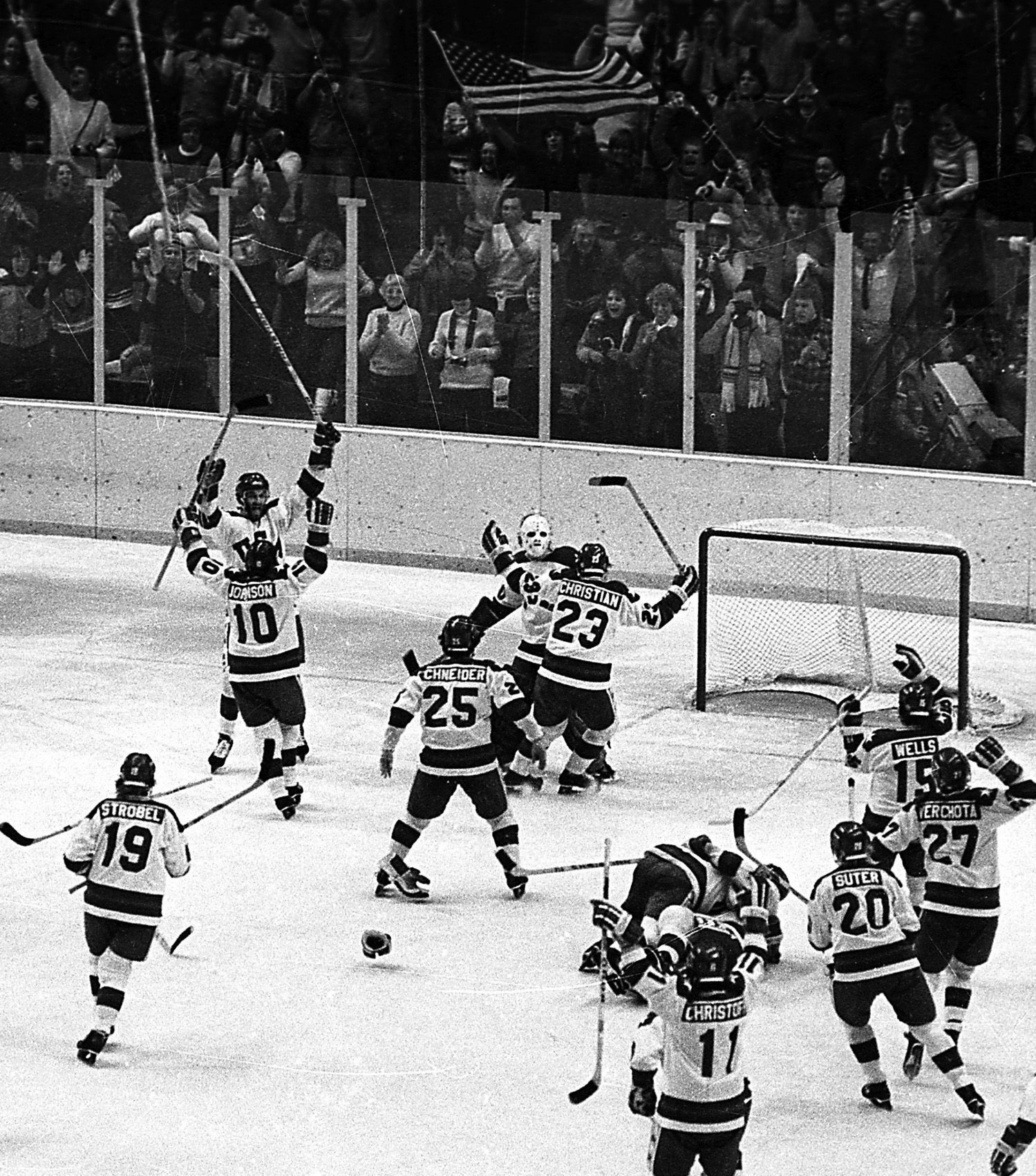 In this Feb. 22, 1980, file photo, the United States ice hockey team rushes toward goalie Jim Craig after their 4-3 upset win over the Soviet Union in the semi-final round of the XIII Winter Olympic Games in Lake Placid, N.Y. (AP Photo/File)