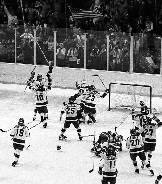 In this Feb. 22, 1980, file photo, the United States ice hockey team rushes toward goalie Jim Craig after their 4-3 upset win over the Soviet Union in the semi-final round of the XIII Winter Olympic Games in Lake Placid, N.Y. (AP Photo/File)