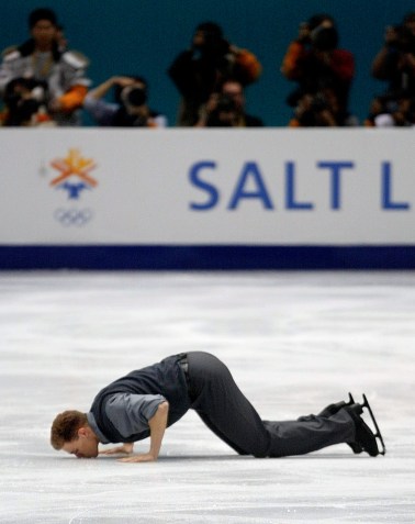 Canadian figure skater David Pelletier kisses the ice after competing in the pairs free program in the Olympic Winter Games at the Salt Lake Ice Center in Salt Lake City, Monday, Feb. 11, 2002. (AP Photo/Roberto Borea)