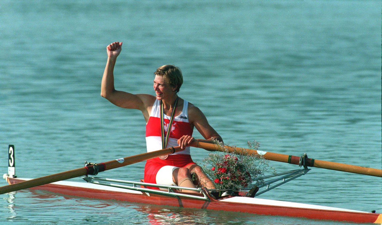 Silken in boat smiling with fist in the air