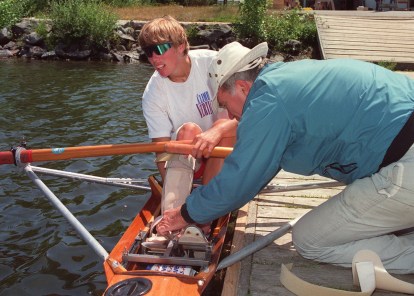Rower Silken Laumann receives assistance adjusting her leg brace in Victoria Wednesday, June 17, 1992 from friend Peter Smith. Laumann has returned to rowing to help recover from injuries received last month at a meet in Germany. (CP PHOTO/Bruce Stotesbury)