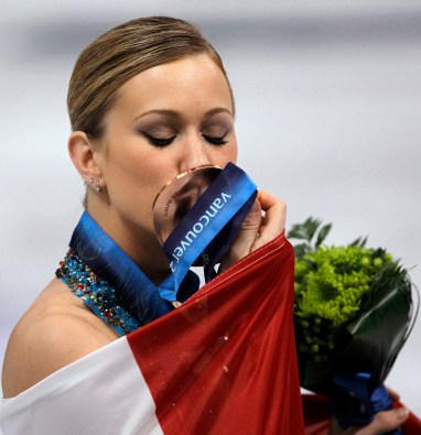 Canada's Joannie Rochette kisses her bronze medal during the victory ceremony for the women's figure skating competition at the Vancouver 2010 Olympics in Vancouver, British Columbia, Thursday, Feb. 25, 2010. (AP Photo/David J. Phillip)