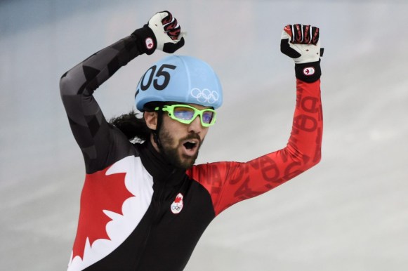 Canada's Charles Hamelin celebrates his gold medal victory in the men's 1500m short track speed skating final at the Sochi 2014 Olympic Winter Games Monday, February 10, 2014 in Sochi. THE CANADIAN PRESS/Paul Chiasson