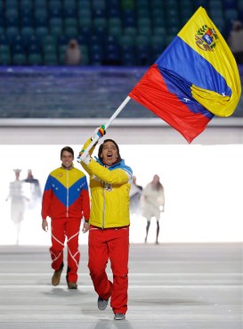 Antonio Pardo of Venezuela carries the national flag as he leads the team during the opening ceremony of the 2014 Olympic Winter Games in Sochi, Russia, Friday, Feb. 7, 2014. (AP Photo/Mark Humphrey)