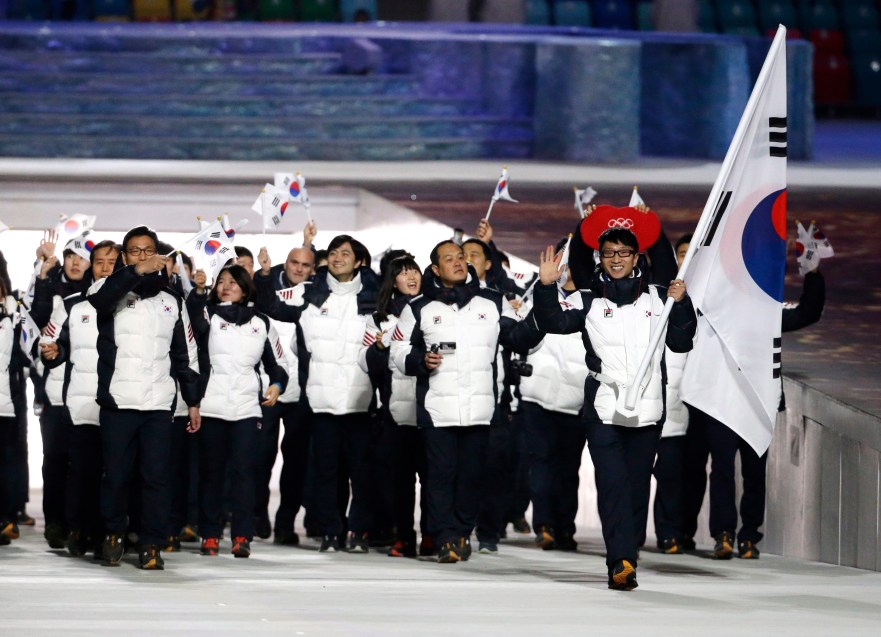 Lee Kyou-Hyuk of South Korea carries the national flag as he leads the team during the opening ceremony of the 2014 Olympic Winter Games in Sochi, Russia, Friday, Feb. 7, 2014. (AP Photo/Mark Humphrey)