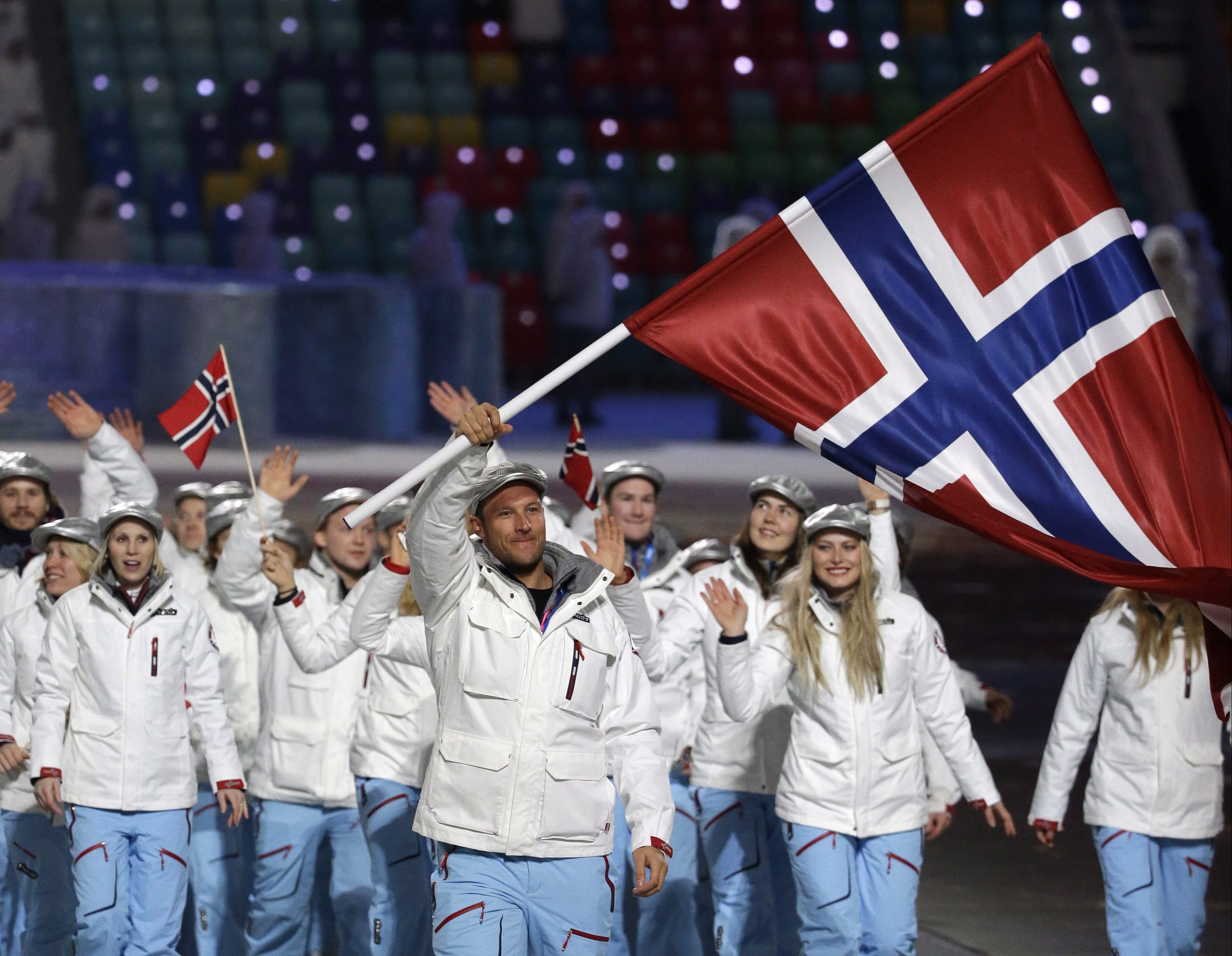 Aksel Lund Svindal of Norway carries the national flag as he leads the team during the opening ceremony of the 2014 Olympic Winter Games in Sochi, Russia, Friday, Feb. 7, 2014. (AP Photo/Mark Humphrey)