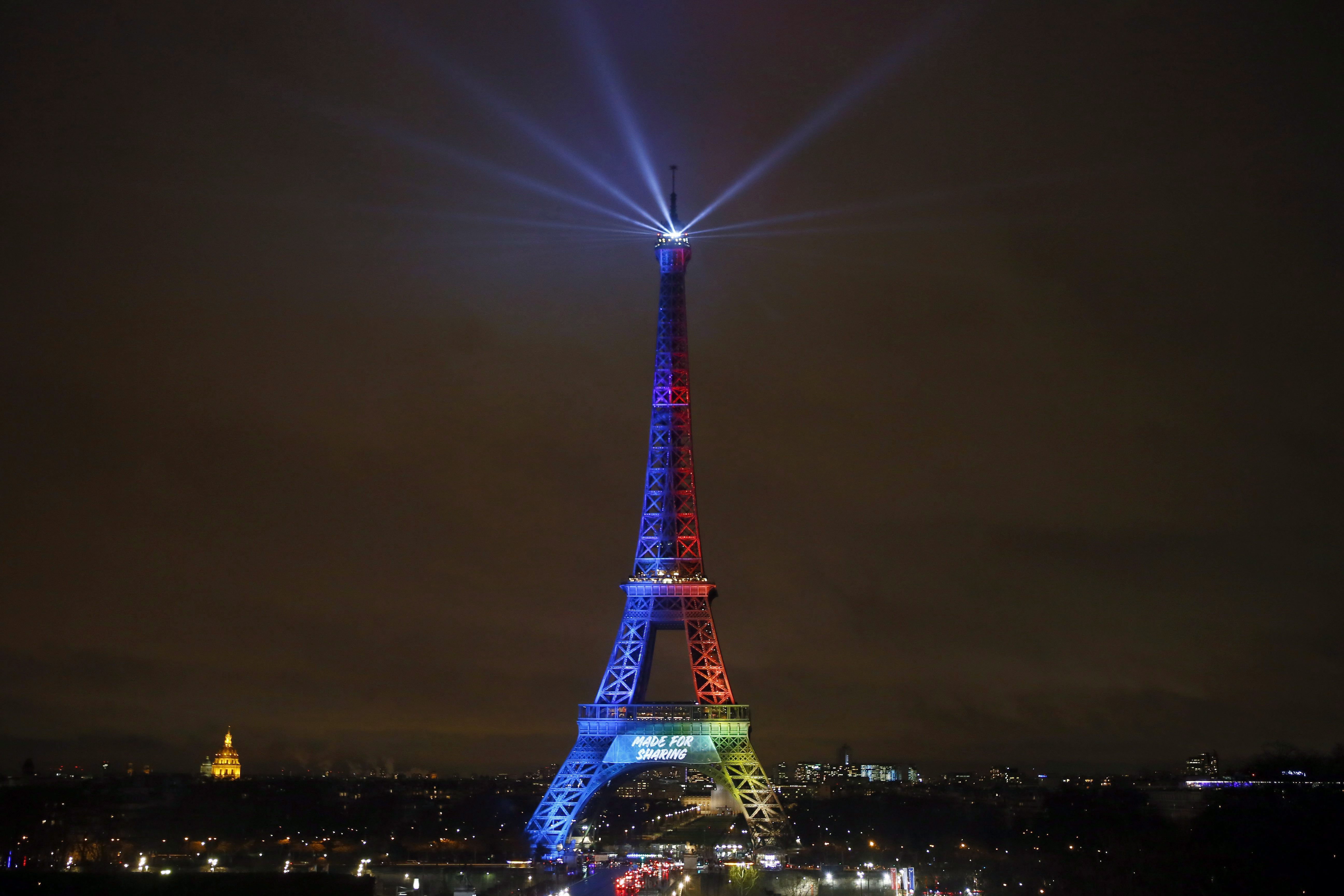 Eiffel Tower is lit with colors for Paris 2024