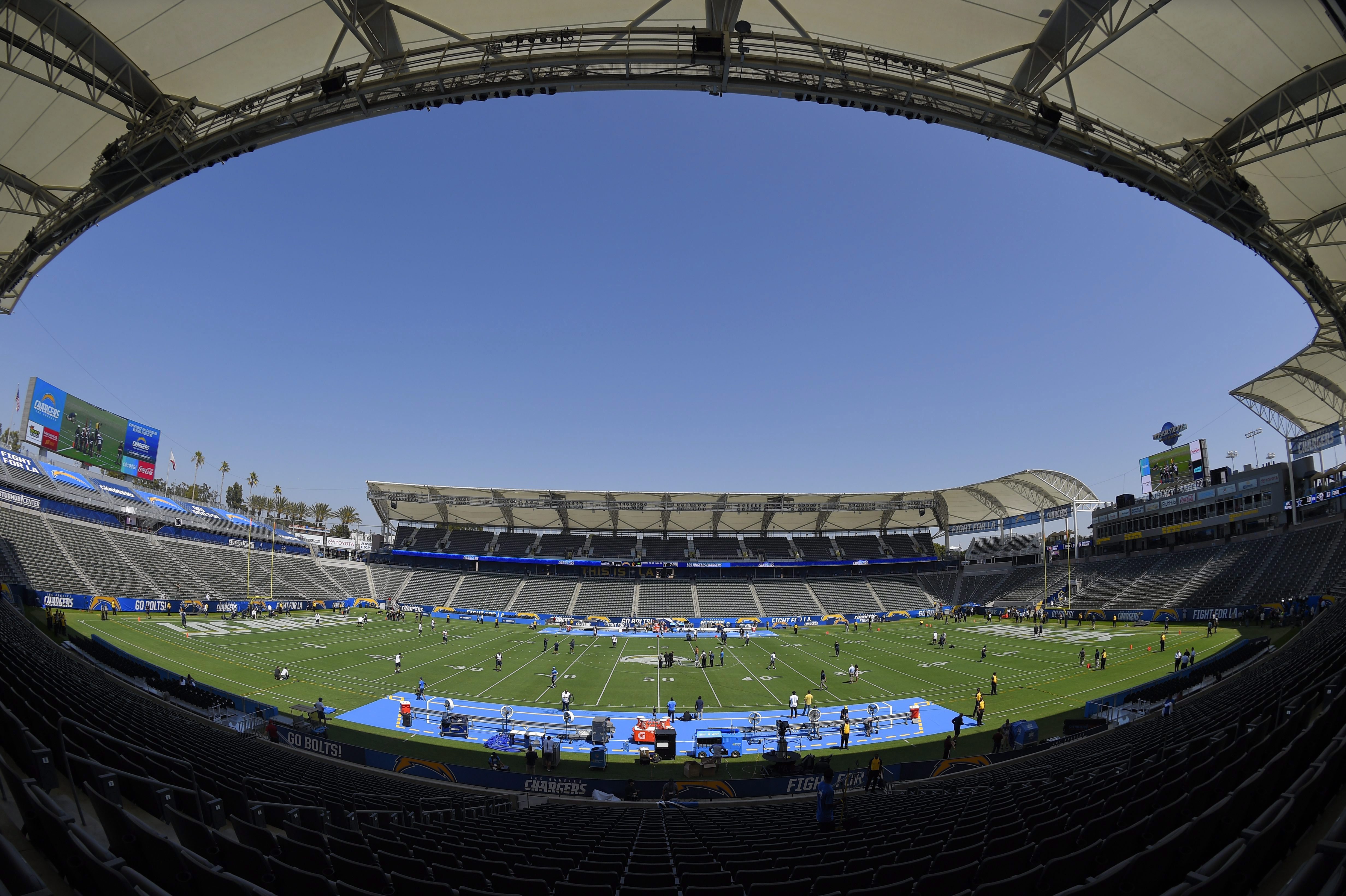 Players for the Seattle Seahawks and the Los Angeles Chargers walk on the field before a preseason NFL football game at the StubHub Center, Sunday, Aug. 13, 2017, in Carson, Calif. (AP Photo/Mark J. Terrill)