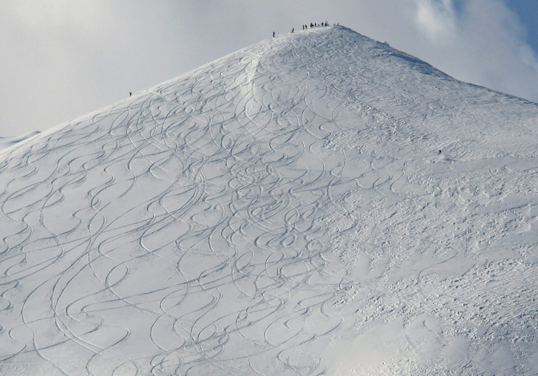 In this Feb. 3, 2011 photo, skiers stand atop the summit of Hanazono ski course in Niseko, northern Japan. Foreign tourists and investors have flocked to scenic Niseko in recent years, giving this rural region a badly needed economic jolt. (AP Photo/Koji Sasahara)