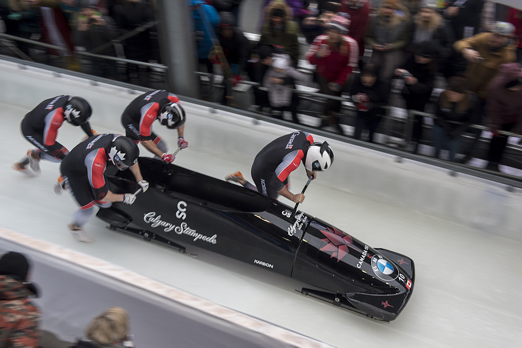 Team Canada - Justin Kripps, Alexander Kopacz, Jessee Lumsden, and Oluseyi Smith push their sled