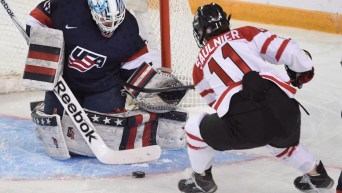 United States goalie Alex Rigsby makes a save on a shot by Canada's Jillian Saulnier