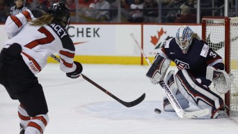 The United States goalie Alex Rigsby saves the shot by Canada's Laura Stacey