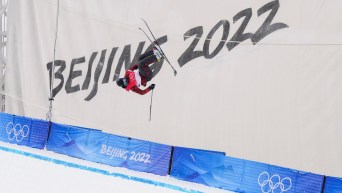Simon d'Artois performs an acrobatic trick in ski halfpipe