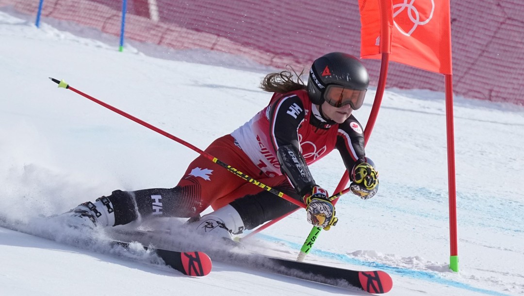 Valerie Grenier in a lean as she skis past a gate
