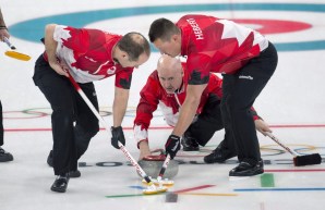 Canada skip Kevin Koe follows his front end of second Brent Laing