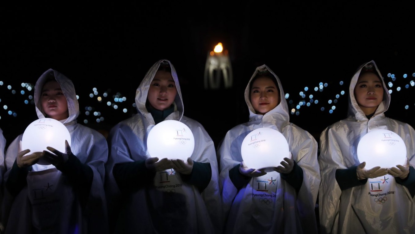 Performers carry lights during the closing ceremony of the 2018 Winter Olympics in Pyeongchang, South Korea, Sunday, Feb. 25, 2018. (AP Photo/Natacha Pisarenko)