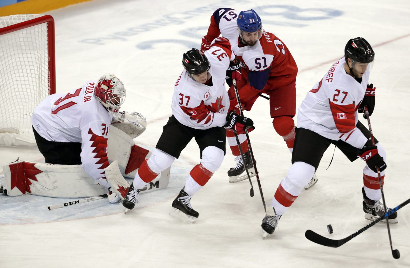 Mat Robinson and Cody Goloubef of Canada battle for the puck in the Men's Bronze Medal hockey game against the Czech Republic at the Gangneung Hockey Centre during the PyeongChang 2018 Olympic Winter Games in PyeongChang, South Korea on February 24, 2018. (Photo by Vaughn Ridley/COC)