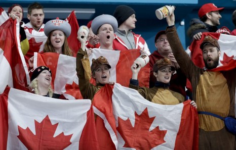 Canada's fans celebrate winning gold at the end of a mixed doubles final curling match against Switzerland at the 2018 Winter Olympics in Gangneung, South Korea, Tuesday, Feb. 13, 2018. (AP Photo/Natacha Pisarenko)