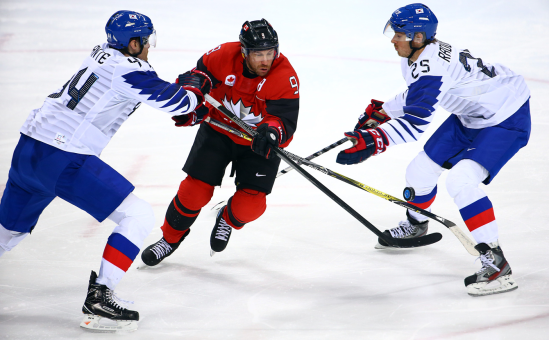 Team Canada's Derek Roy skates past two South Koreans in men's ice hockey action at PyeongChang 2018 on Feb. 18, 2018. (COC Photo/Vaughn Ridley)