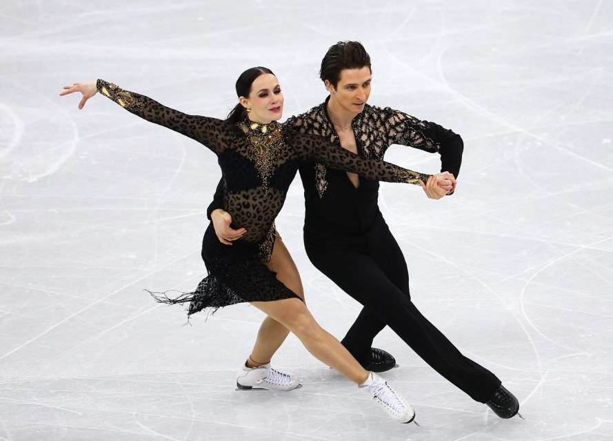 Team Canada Tessa Virtue Scott Moir Tessa Virtue and Scott Moir in competition at the PyeongChang Games. Both are dressed in all black outfits.