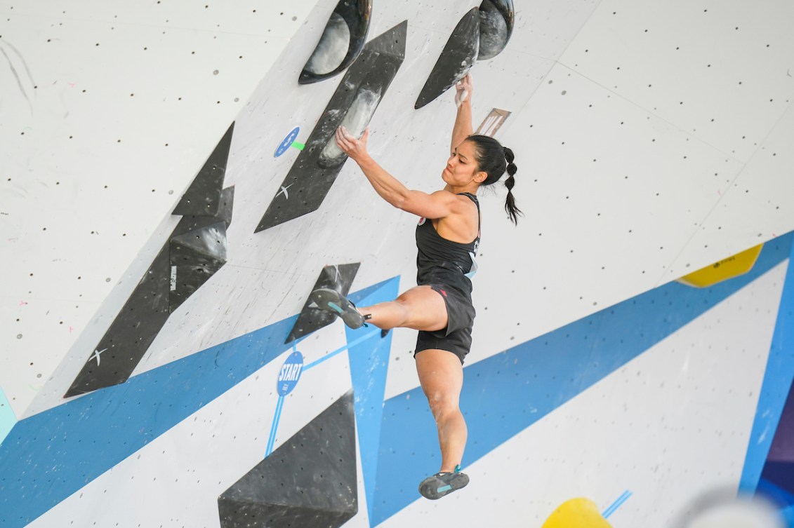 Alannah Yip navigates a black bouldering route 