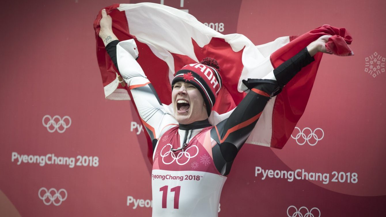 Gough cheering holding Canadian flag