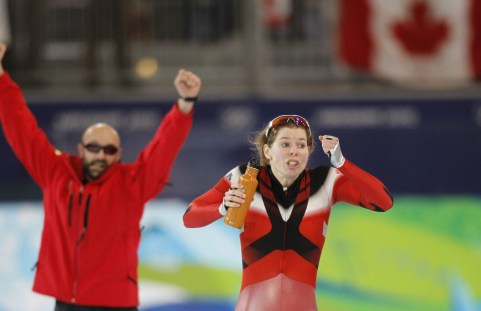 Gold medallist Canada's Christine Nesbitt, right, and her coach react as she waits for the outcome of the last race during the women's 1000 meters race at the Richmond Olympic Oval at the Vancouver 2010 Olympics in Vancouver, British Columbia, Thursday, Feb. 18, 2010. (AP Photo/Kevin Frayer)