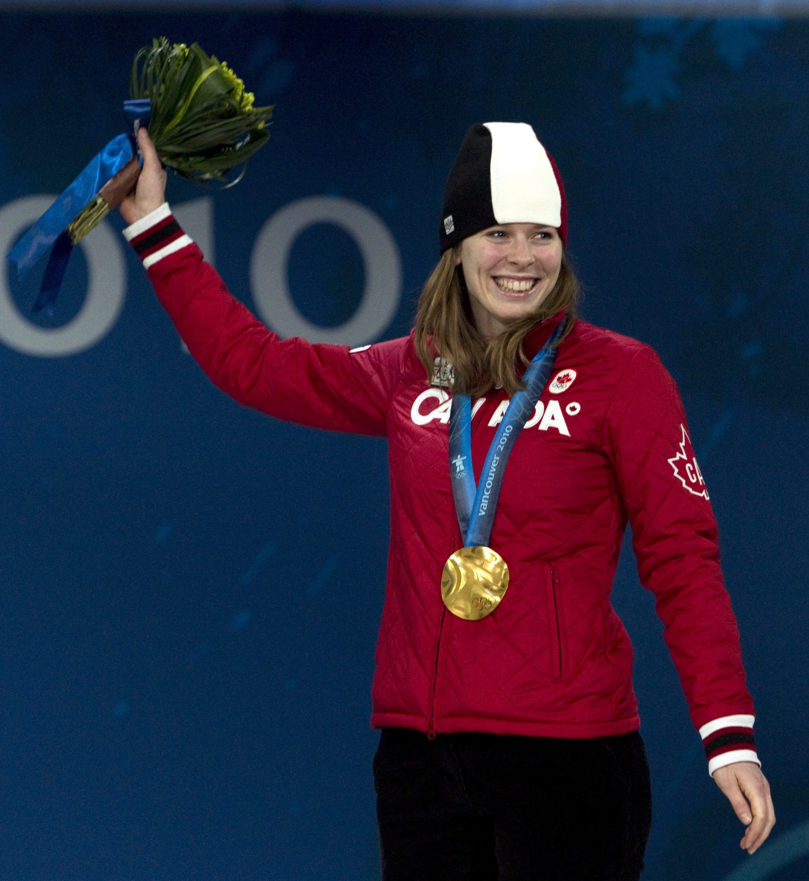 Canadian speedskater Christine Nesbitt, from London, Ont., stands on the podium after receiving her gold medal for the women's long-track 1,000m competition during the medal ceremonies in Vancouver, BC Thursday Feb. 18, 2010. THE CANADIAN PRESS/Adrian Wyld