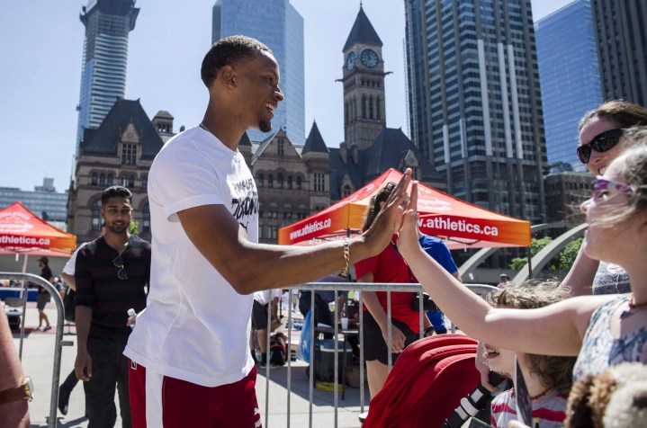 Olympic medalist Andre De Grasse greets fans during a street exhibition of track and field at Nathan Phillips Square in Toronto on Tuesday, June 12, 2018. THE CANADIAN PRESS/Christopher Katsarov