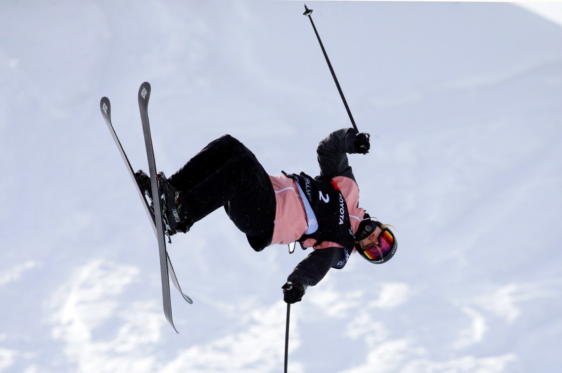 Freestyle skiier flips in the air 