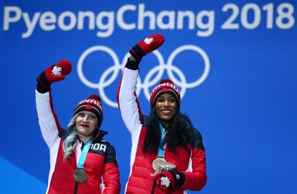 Kaillie Humpries and Phylicia George wave to the crowd with their bronze