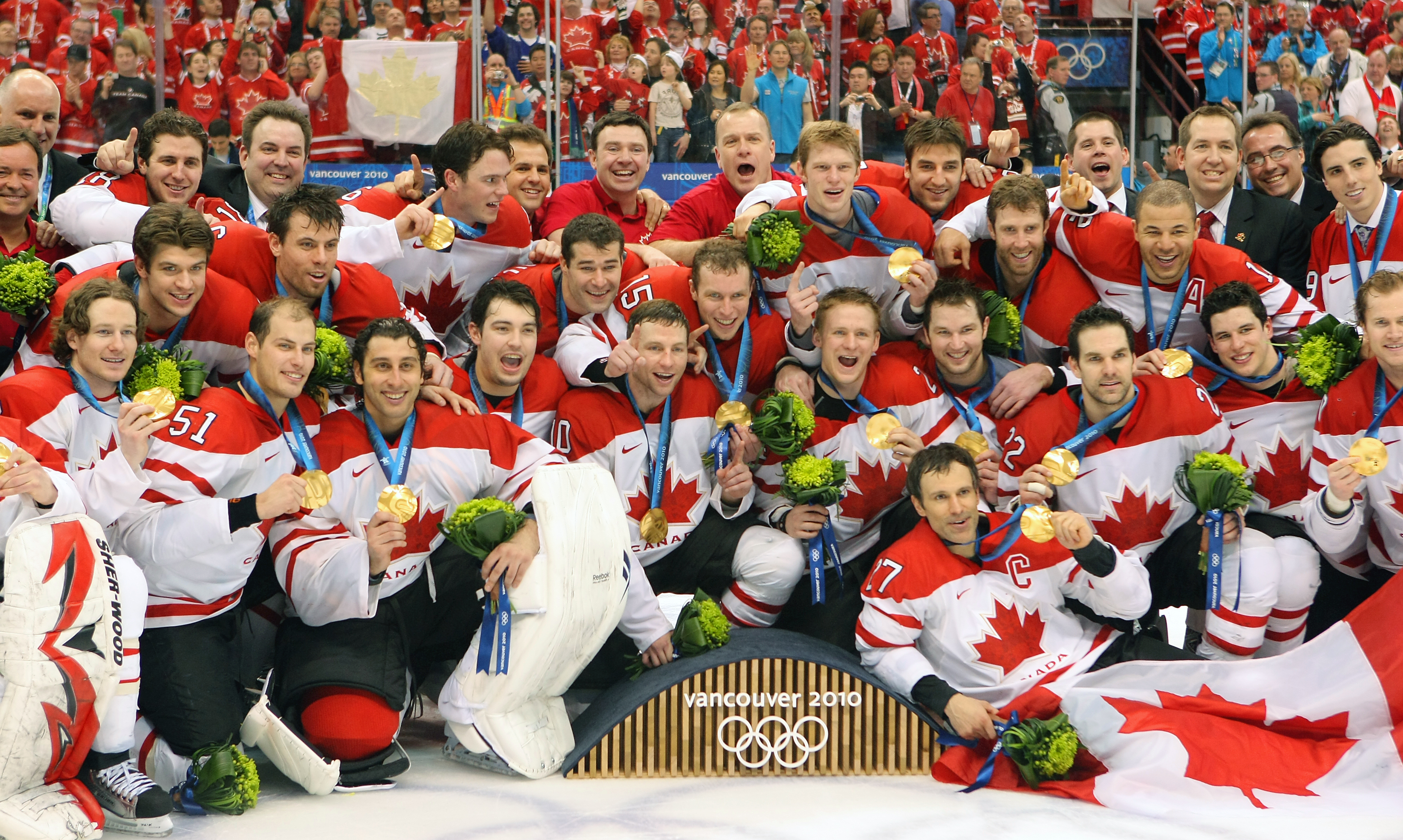 The men's hockey team pose with their gold medals at Vancouver 2010