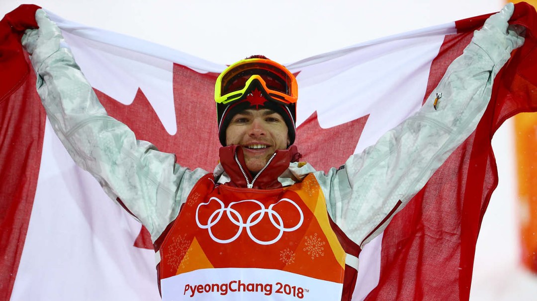 Mikael Kingsbury posing with Canadian flag