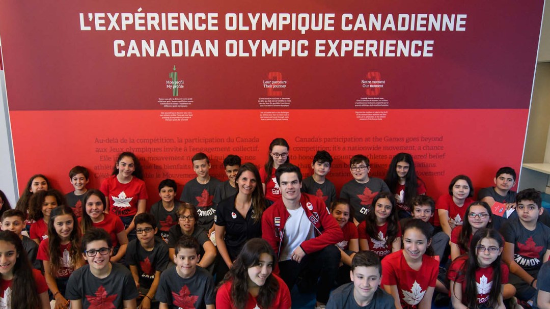 Olympic athletes sitting with children