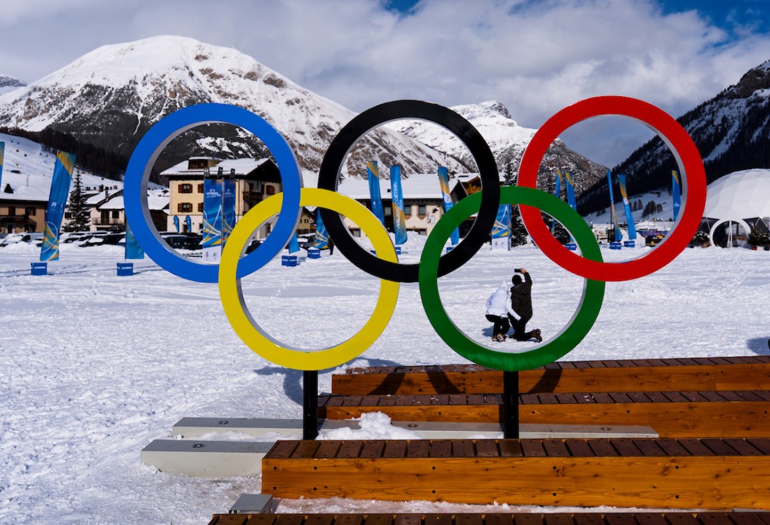 Olympic rings in foreground, town of Livigno behind