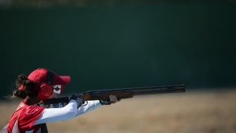 Shooting athlete aiming rifle