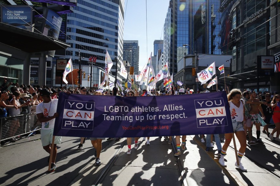 People marching with flags at the Pride Parade