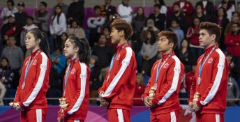 Canada's taekwondo team stands with medals