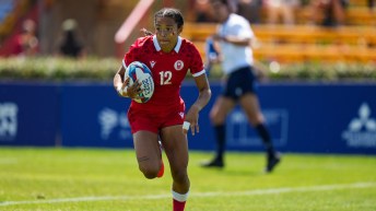 Team Canada rugby player runs with the ball