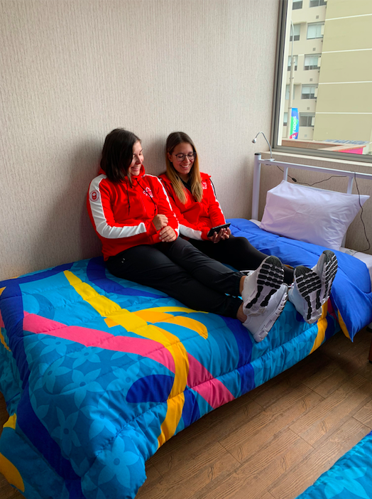 Athletes hanging out in their room at the village