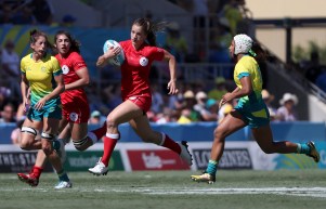 Canada's Caroline Crossley attempts to run past Australian defenders during their rugby sevens semifinal