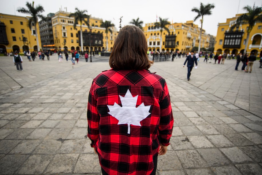 Woman with maple leaf flannel site seeing in Lima