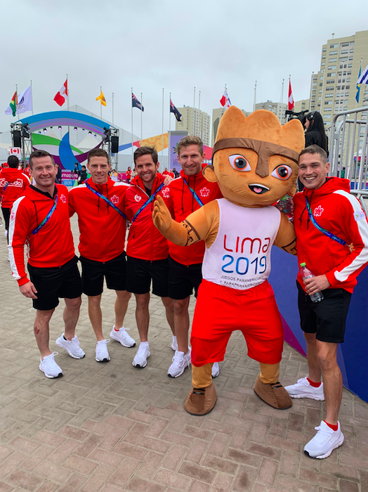 Athletes pose with mascot