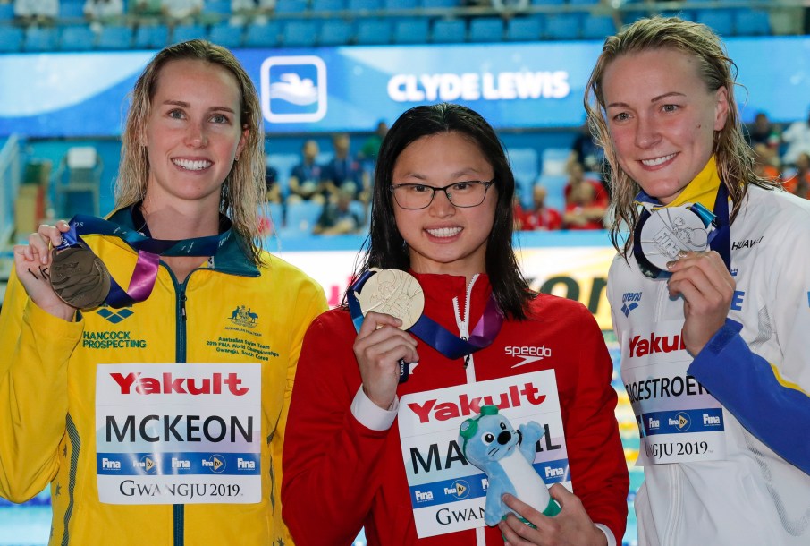 Gold medalist Canada's Margaret MacNeil, centre, stands with silver medalist Sweden's Sarah Sjostrom, right, and bronze medalist Australia's Emma McKeon