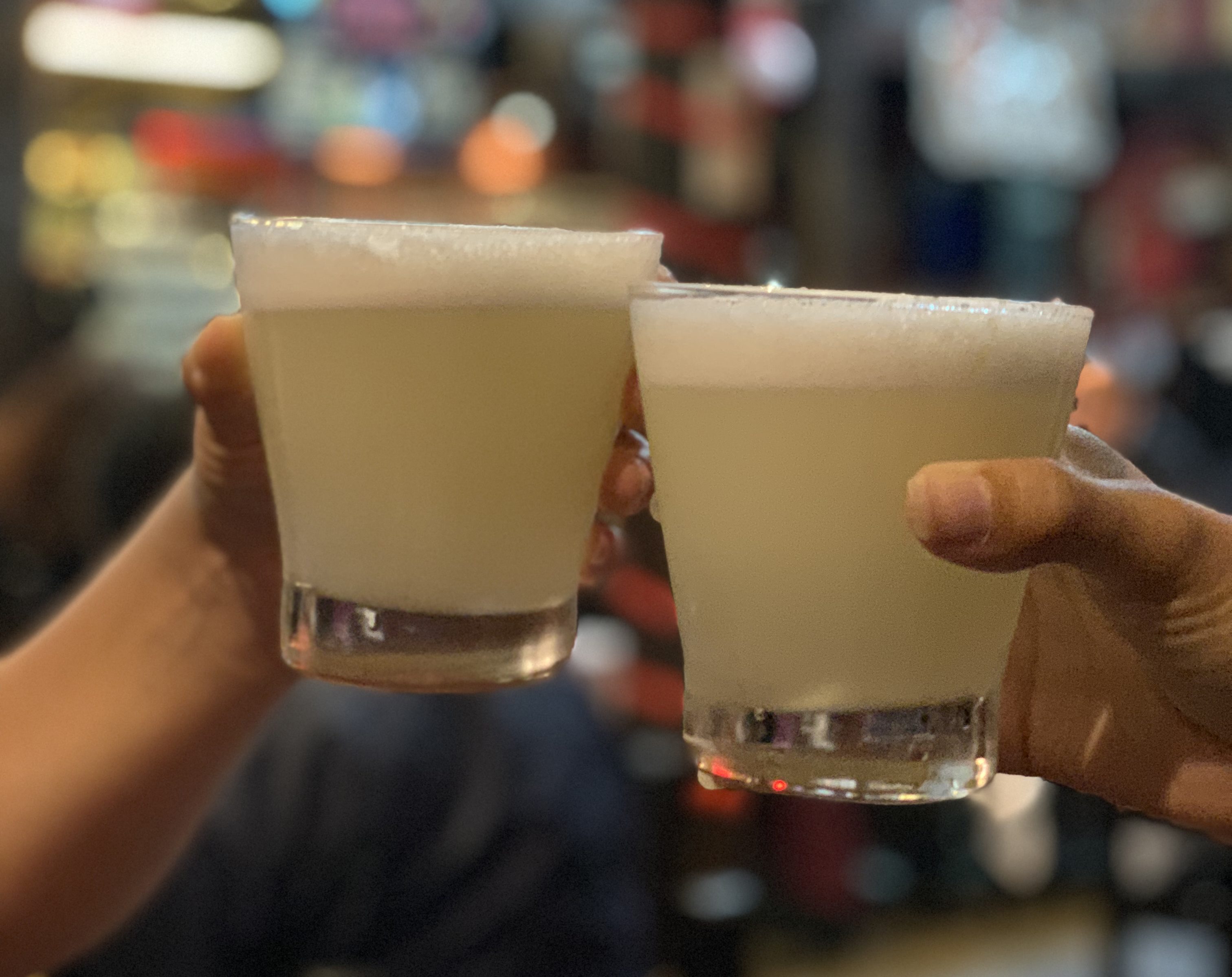 Green/yellow drink with foamy egg whites on top