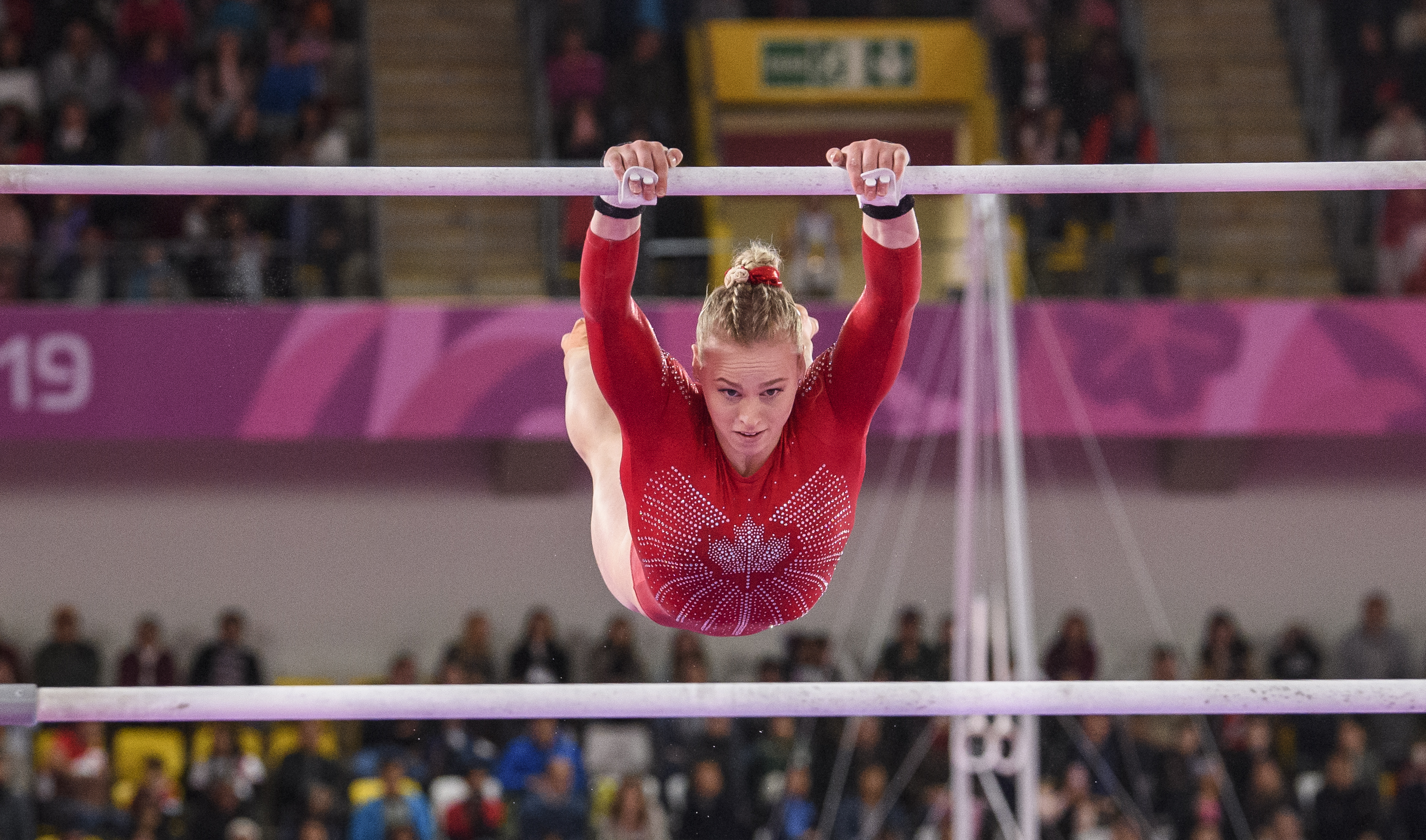 Gymnast swings on the uneven bars