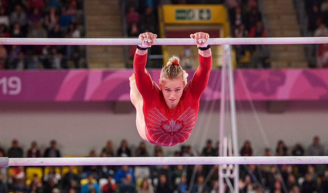 Gymnast swings on the uneven bars
