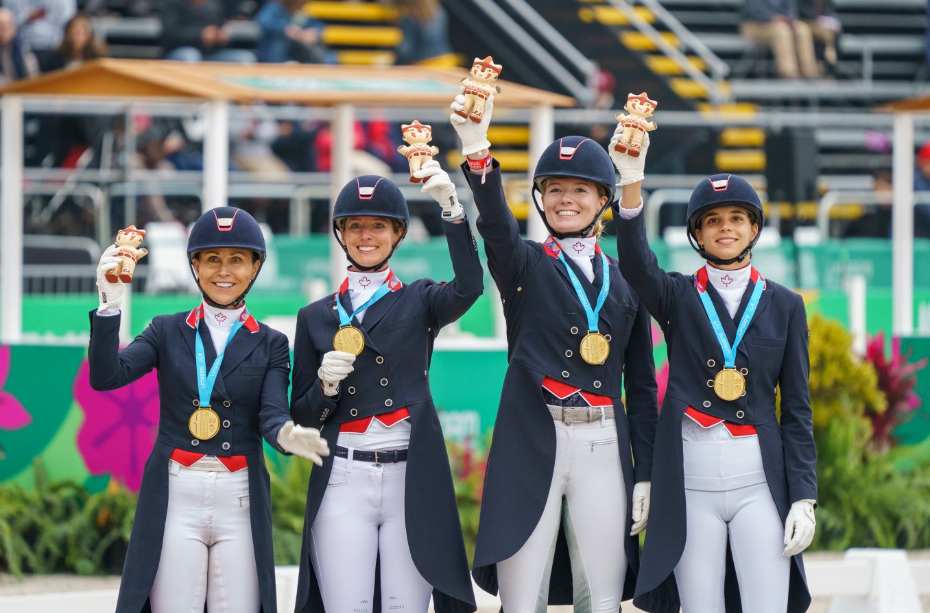 Four riders pose with their medals and Milko stuffed animals